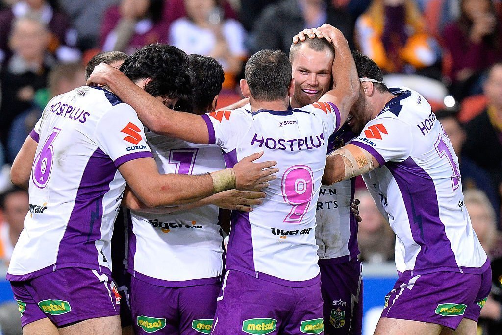 BRISBANE, AUSTRALIA - JULY 01: Cheyse Blair of the Storm is congratulated by team mates after scoring a try during the round 17 NRL match between the Brisbane Broncos and the Melbourne Storm at Suncorp Stadium on July 1, 2016 in Brisbane, Australia. (Photo by Bradley Kanaris/Getty Images)